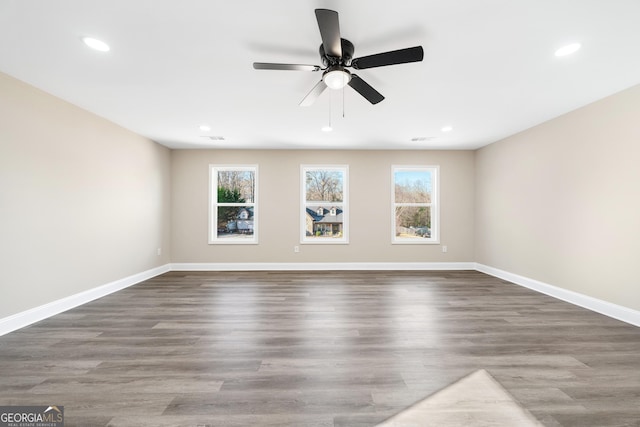 spare room featuring ceiling fan and dark hardwood / wood-style flooring