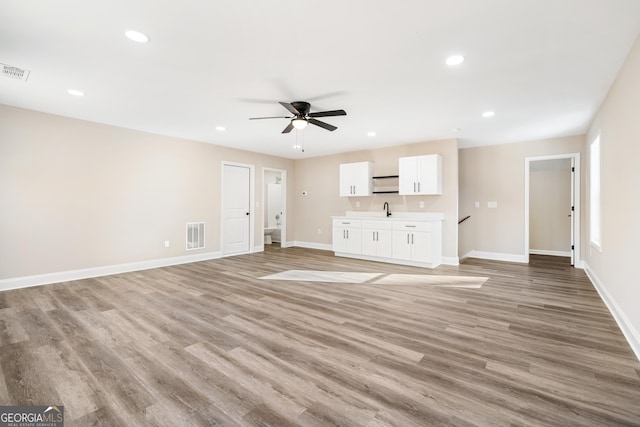 526 Whirlway St, Jefferson, GA 30549 - unfurnished living room with a ceiling fan, baseboards, light wood-style flooring, a sink, and recessed lighting
