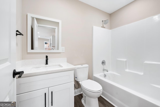 full bathroom featuring hardwood / wood-style floors, toilet, vanity, and shower / bathing tub combination