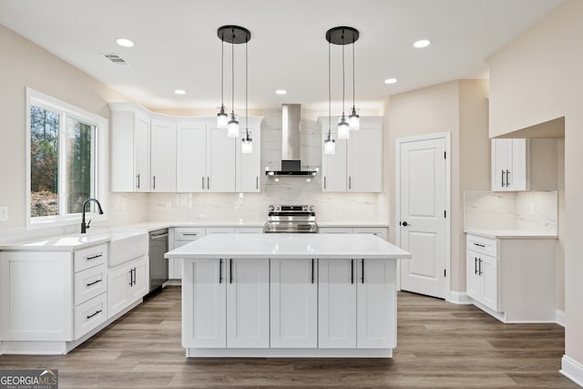 526 Whirlway St, Jefferson, GA 30549 - kitchen with wall chimney exhaust hood, stainless steel appliances, a kitchen island, a sink, and backsplash