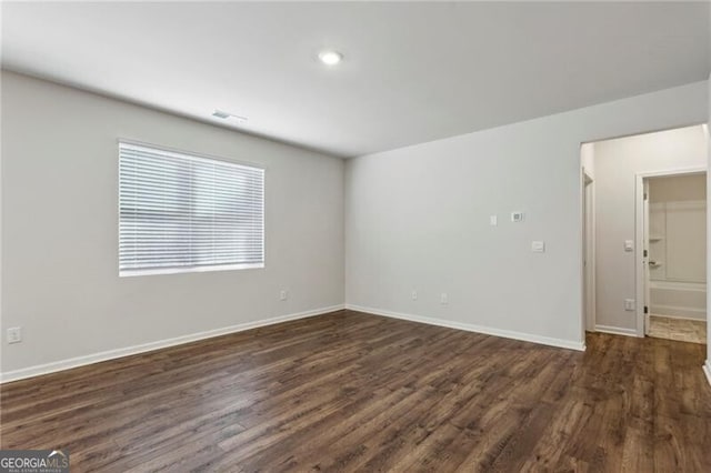 spare room with dark wood-type flooring