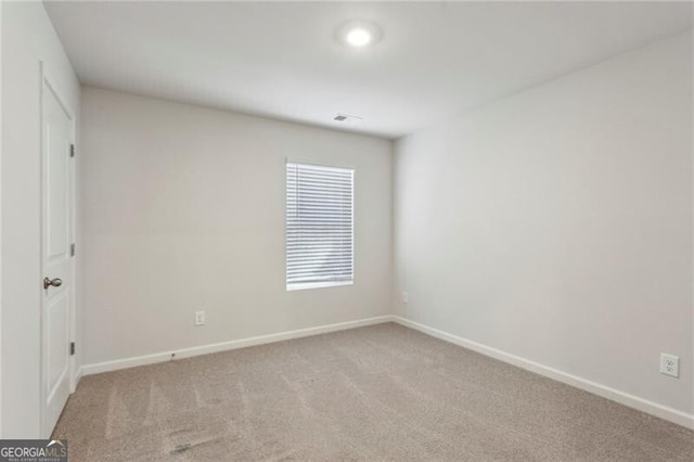 unfurnished room featuring light carpet