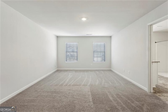 empty room featuring light colored carpet