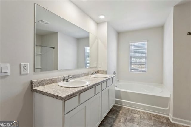 bathroom featuring a tub and vanity