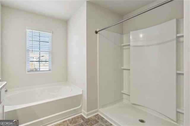 bathroom featuring vanity, a wealth of natural light, and plus walk in shower