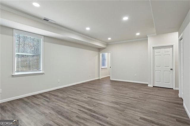 basement with crown molding and dark hardwood / wood-style flooring