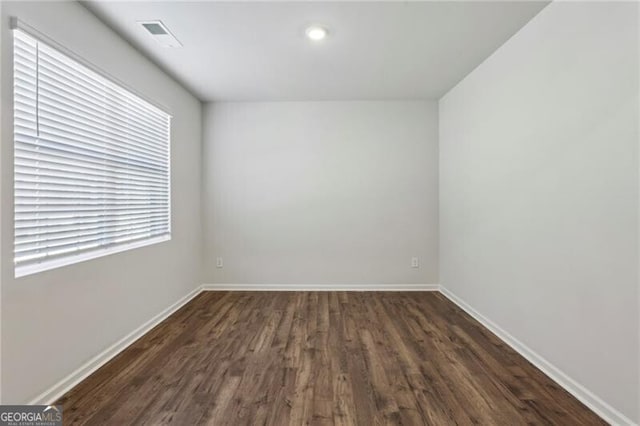 empty room featuring dark wood-type flooring