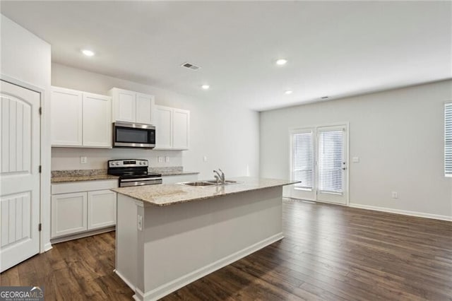 kitchen featuring sink, white cabinets, a kitchen island with sink, and appliances with stainless steel finishes