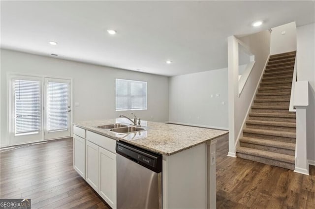 kitchen with stainless steel dishwasher, sink, dark wood-type flooring, white cabinetry, and a kitchen island with sink