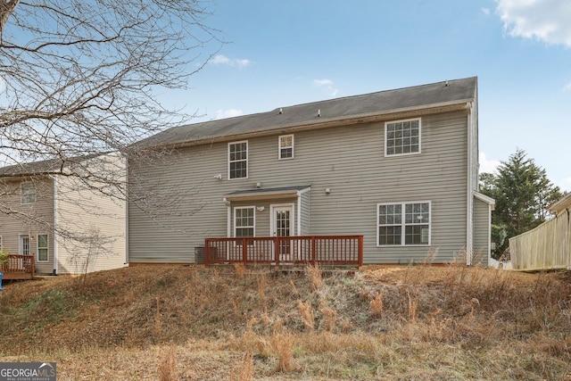 rear view of house featuring a wooden deck