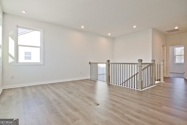 unfurnished room with light hardwood / wood-style flooring