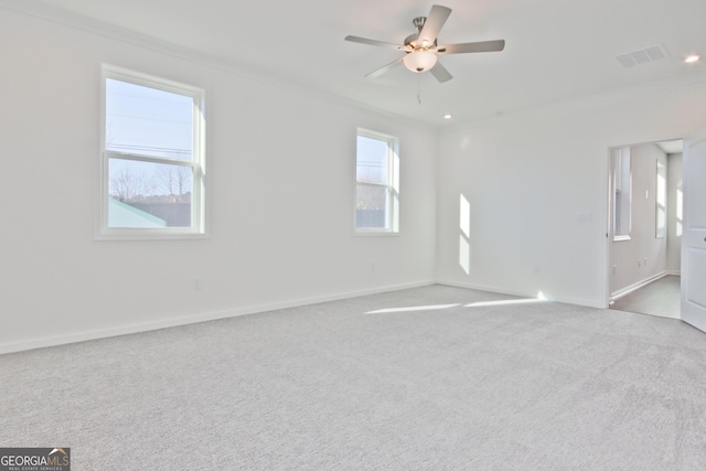 carpeted spare room with crown molding and ceiling fan