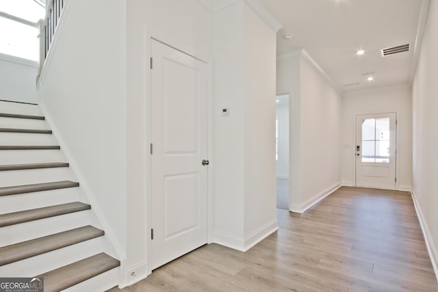 entrance foyer featuring light hardwood / wood-style floors and ornamental molding