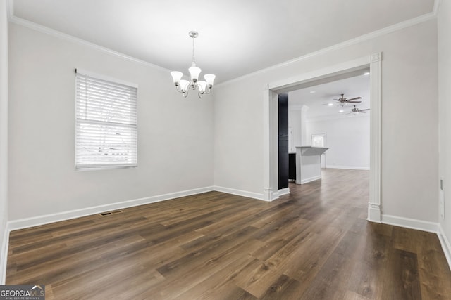 unfurnished dining area with ceiling fan with notable chandelier, ornamental molding, and dark hardwood / wood-style floors