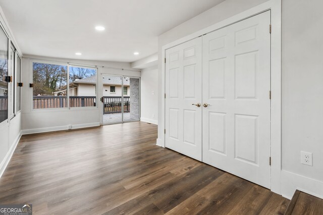 kitchen with dark hardwood / wood-style flooring, a center island, ornamental molding, and ceiling fan