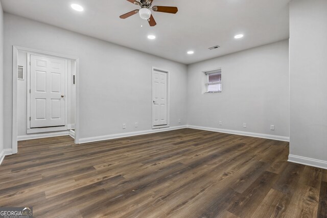 unfurnished living room featuring ceiling fan, ornamental molding, and dark hardwood / wood-style flooring