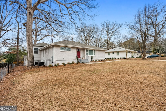 ranch-style home with central AC unit and a front lawn