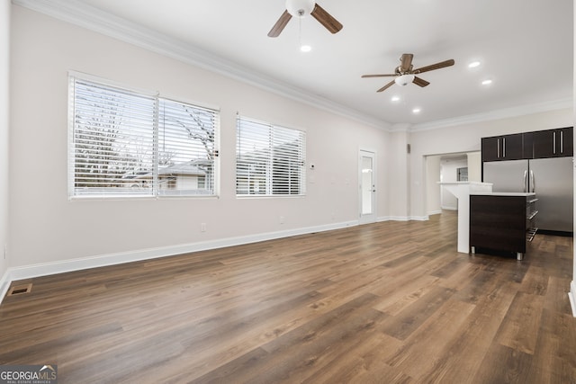 unfurnished living room featuring crown molding, dark hardwood / wood-style floors, and ceiling fan