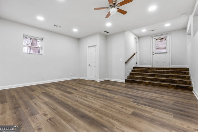 basement with ceiling fan and dark hardwood / wood-style flooring