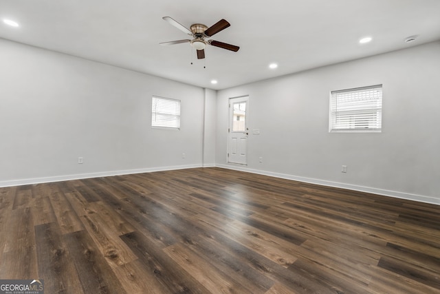 empty room featuring ceiling fan and dark hardwood / wood-style flooring