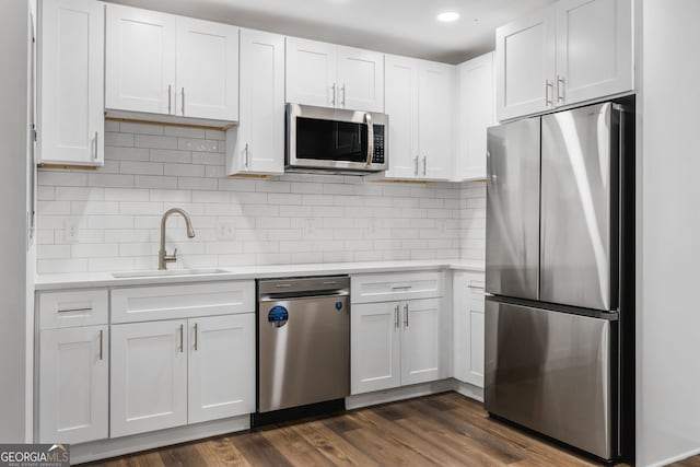 kitchen featuring sink, white cabinets, dark hardwood / wood-style flooring, and stainless steel appliances