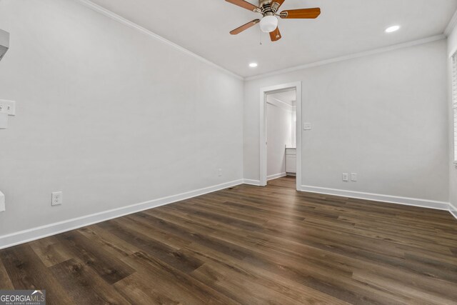 empty room featuring ceiling fan, dark wood-type flooring, and ornamental molding