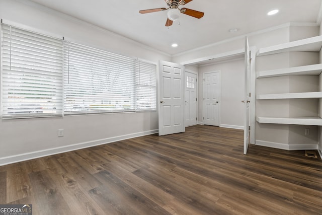 unfurnished bedroom with crown molding, dark hardwood / wood-style floors, and ceiling fan