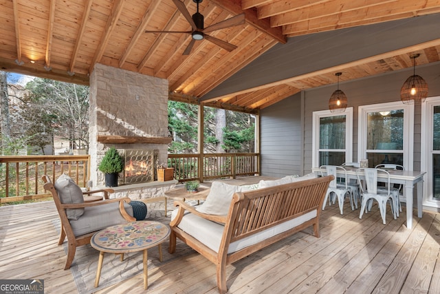 deck with ceiling fan and an outdoor living space with a fireplace