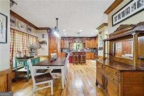 dining area with light hardwood / wood-style floors and ornamental molding