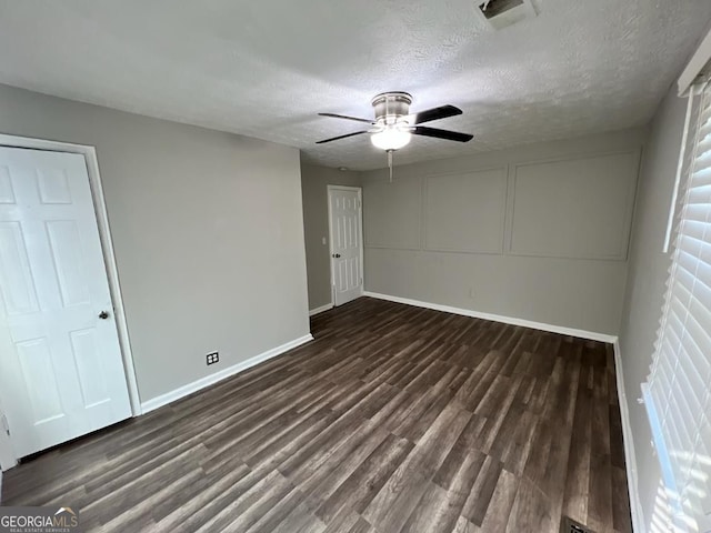 unfurnished bedroom featuring a textured ceiling, dark hardwood / wood-style floors, and ceiling fan