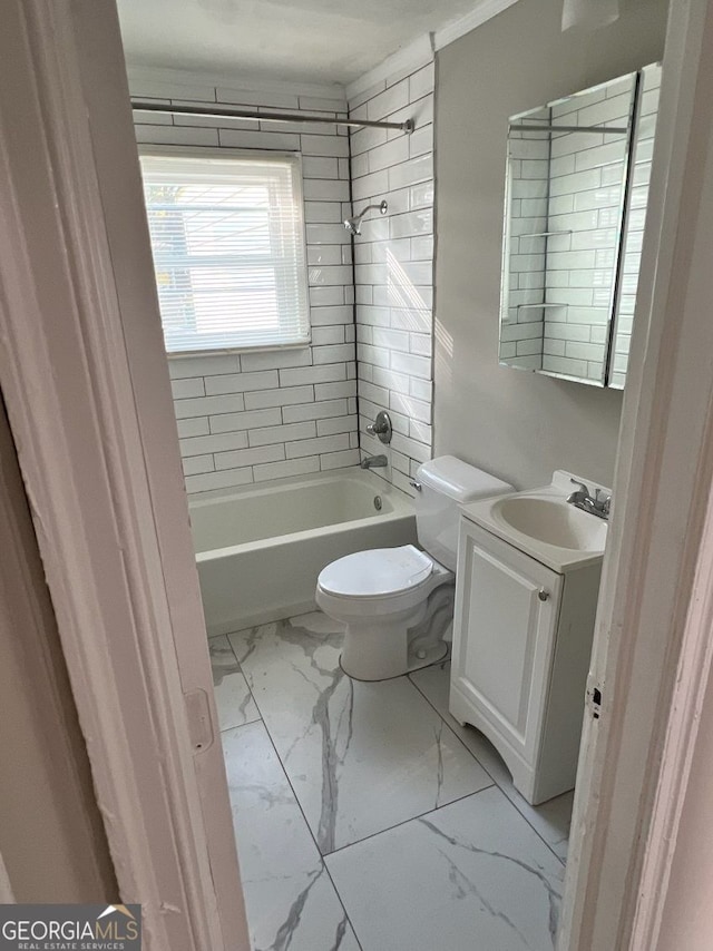 full bath featuring washtub / shower combination, marble finish floor, vanity, and toilet