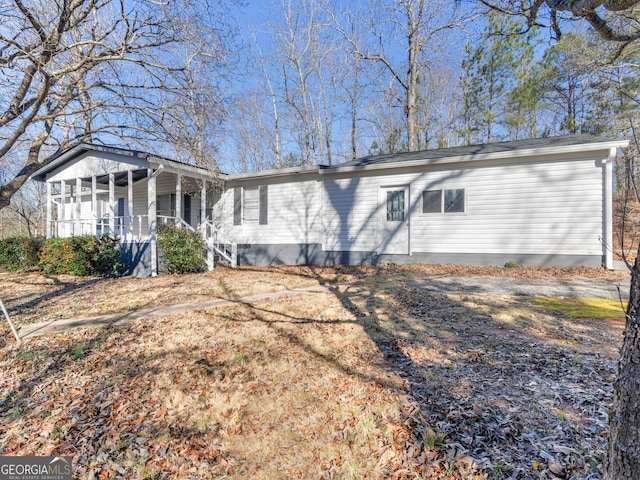 back of property with covered porch