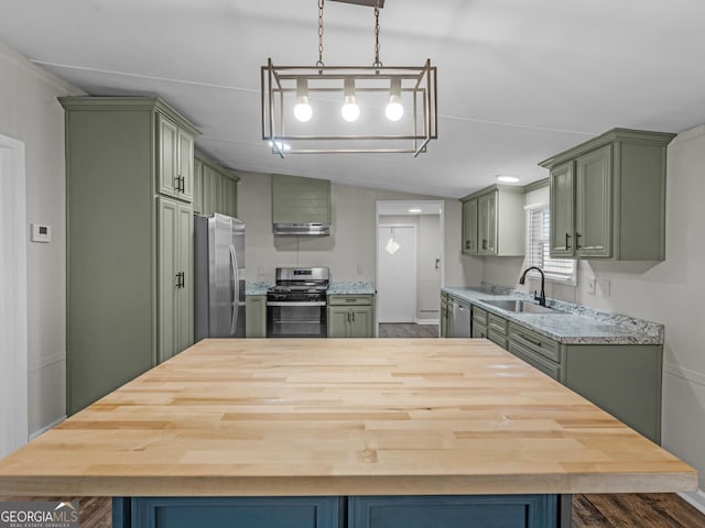 kitchen with green cabinetry, appliances with stainless steel finishes, sink, and lofted ceiling