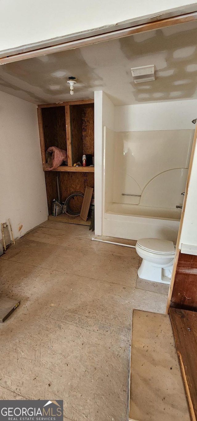 bathroom featuring toilet and walk in shower