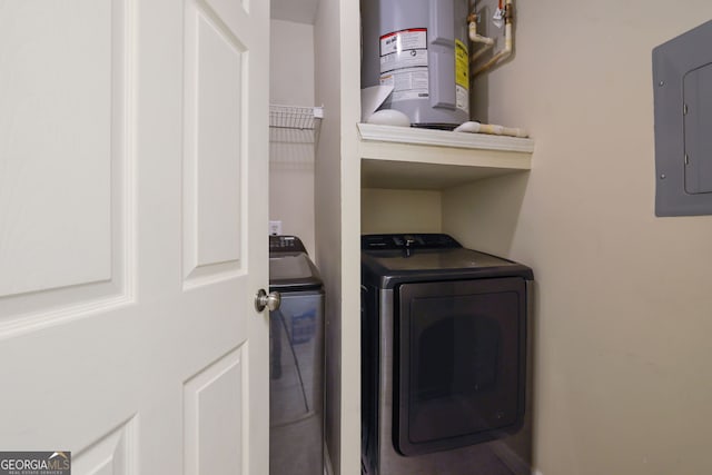 clothes washing area with water heater, electric panel, and independent washer and dryer