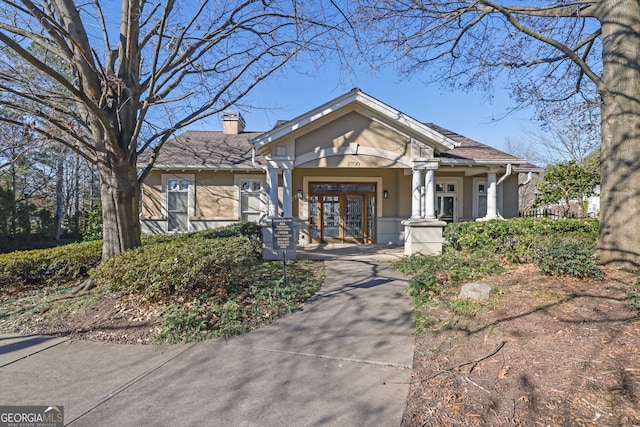 2700 Pine Tree Rd NE Unit 2306, Atlanta, GA 30324 - view of front of home with stucco siding, a chimney, and french doors