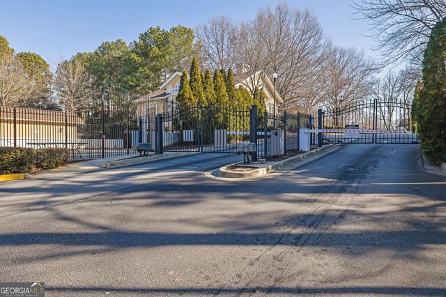 2700 Pine Tree Rd NE Unit 2306, Atlanta, GA 30324 - view of street featuring a gated entry, a gate, and curbs
