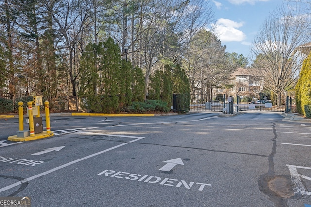 2700 Pine Tree Rd NE Unit 2306, Atlanta, GA 30324 - view of street featuring a gated entry, a gate, and curbs
