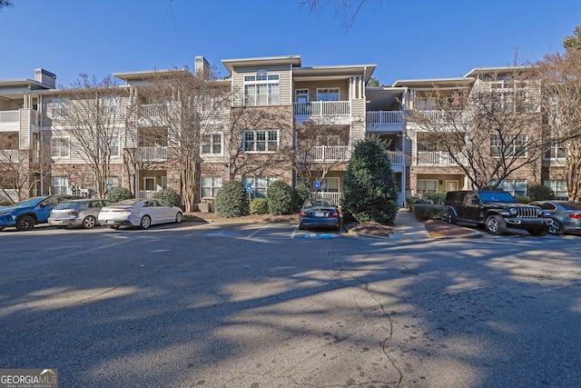2700 Pine Tree Rd NE Unit 2306, Atlanta, GA 30324 - view of building exterior with uncovered parking