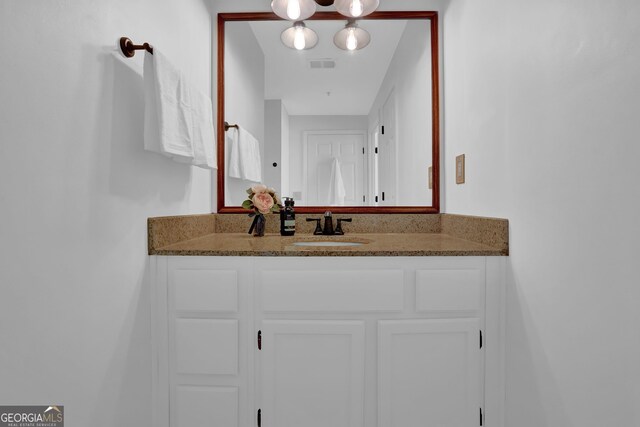 kitchen featuring dark wood-type flooring, sink, white cabinetry, white dishwasher, and light stone countertops