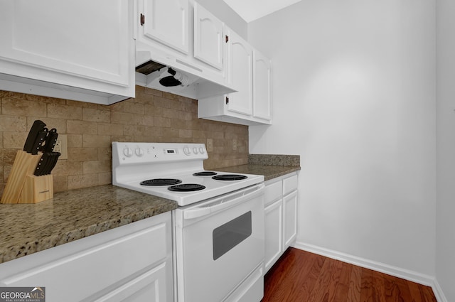 kitchen with white electric stove, white cabinetry, dark wood-type flooring, and dark stone countertops