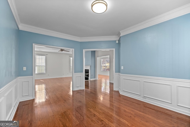 unfurnished room with ceiling fan, hardwood / wood-style flooring, and crown molding