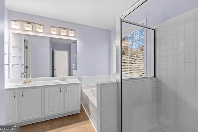 bathroom with vanity, a wealth of natural light, shower with separate bathtub, and tile patterned flooring