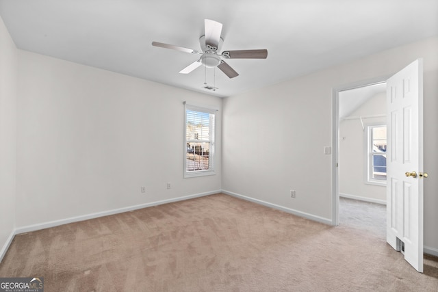 unfurnished room featuring ceiling fan and light colored carpet