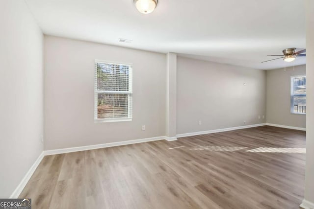 spare room featuring hardwood / wood-style flooring and ceiling fan