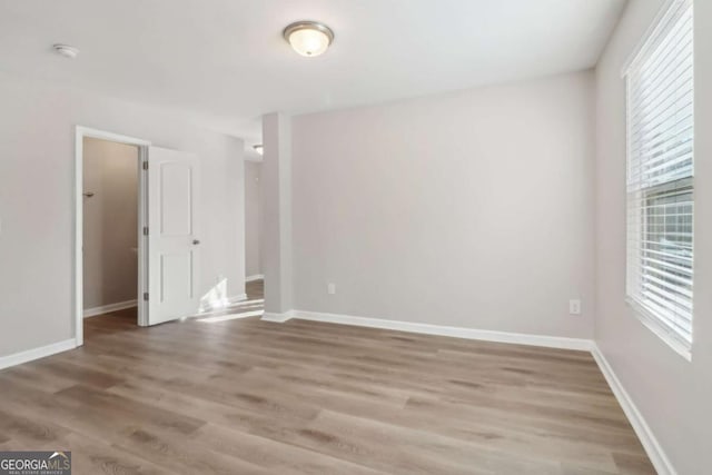 empty room with hardwood / wood-style flooring