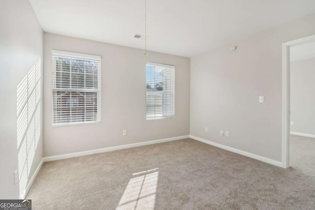 carpeted empty room featuring a healthy amount of sunlight