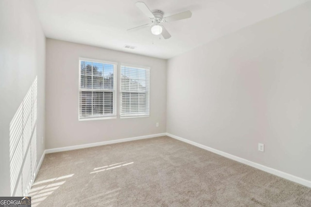 carpeted empty room featuring ceiling fan