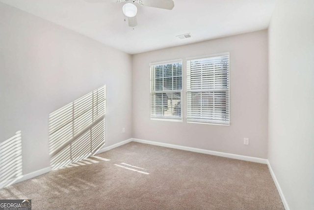 carpeted empty room featuring ceiling fan