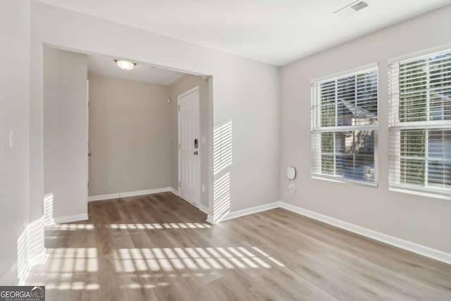 unfurnished room featuring hardwood / wood-style flooring